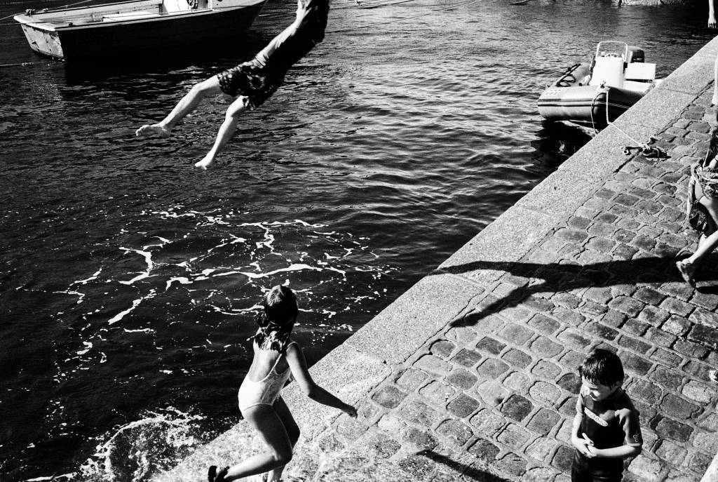 Children playing and jumping in the water