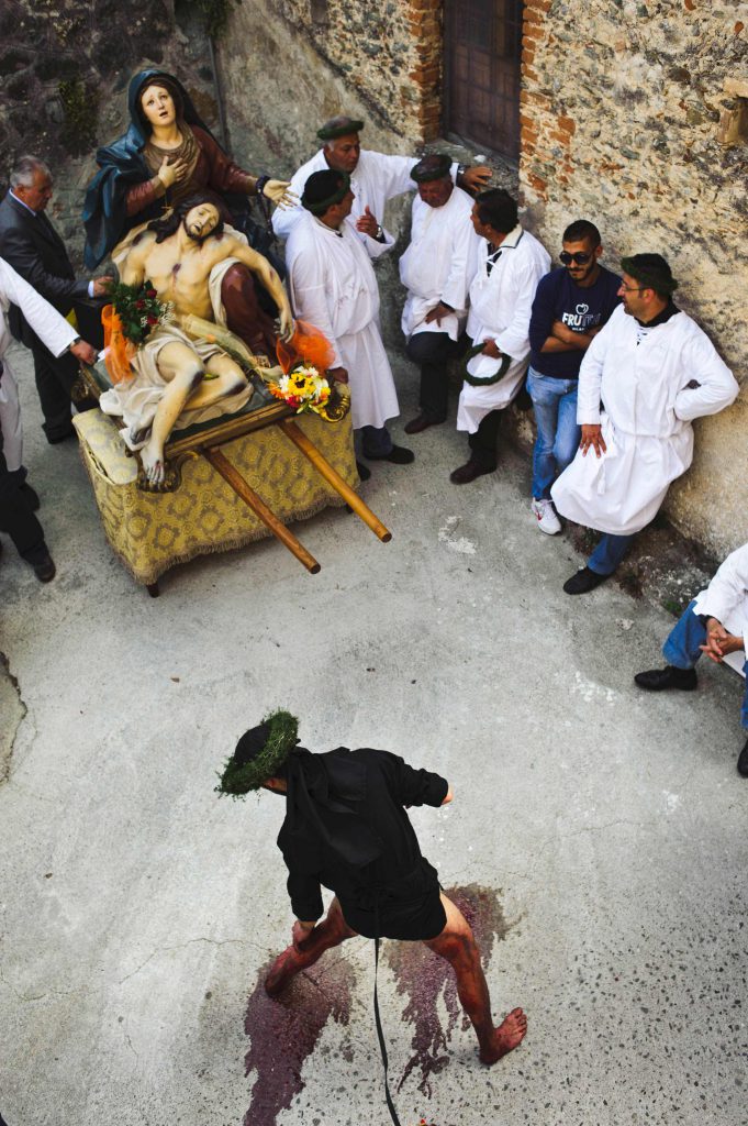 Vattiente scourges himself in front of the statue of the Madonna during the procession of the holy week in Nocera Terinese, Calabria