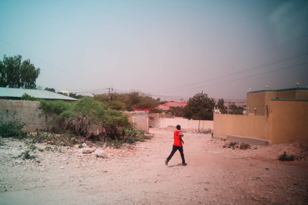 Man with red t-shirt running on a street in Hergeysa, Somaliland