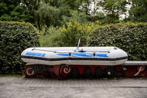 An rubber boat outside the water in a park in Berlin